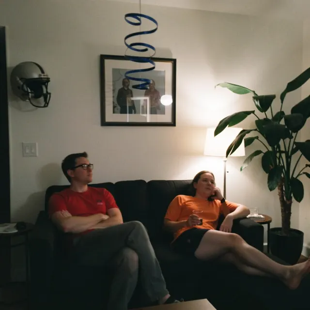 Two people on a dark sofa